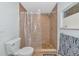 Compact bathroom with a tiled shower, toilet, and small window, offering a functional space at 5860 Brown Ln, Sarasota, FL 34232
