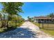 Long private driveway leading to a well-maintained home with a charming front porch at 5860 Brown Ln, Sarasota, FL 34232