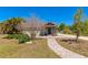 Charming home exterior with a stone walkway and cozy entrance, surrounded by lush greenery at 5860 Brown Ln, Sarasota, FL 34232