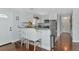Bright kitchen area with white cabinets, granite counters, bar seating, and modern stainless appliances at 5860 Brown Ln, Sarasota, FL 34232