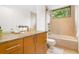 Bathroom featuring a bamboo vessel sink, shower over tub with tile surround and a large mirror at 587 47Th St, Sarasota, FL 34234