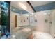 Large primary bathroom with marble countertops, double sinks, two showers, and natural light at 587 47Th St, Sarasota, FL 34234