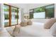 Bright bedroom featuring a king bed with a slider door leading to a view of the pool at 587 47Th St, Sarasota, FL 34234