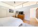Sun-filled bedroom with sleek wood floors and minimalist decor offers a peaceful and uncluttered retreat at 587 47Th St, Sarasota, FL 34234