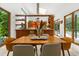 Elegant dining area adjacent to the kitchen with an open layout, natural light, and stylish furnishings at 587 47Th St, Sarasota, FL 34234