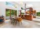 Open-concept dining area featuring modern furnishings, seamless flow to the kitchen, and outdoor views at 587 47Th St, Sarasota, FL 34234