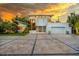 Contemporary two-story home featuring a clean facade, oversized windows, and an expansive concrete driveway at 587 47Th St, Sarasota, FL 34234
