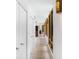 Bright hallway with stone floors, wood framed windows, closets, and recessed lighting at 587 47Th St, Sarasota, FL 34234