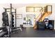 Home gym featuring rubber floors, weightlifting equipment, and access to the second story at 587 47Th St, Sarasota, FL 34234