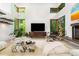 Modern living room boasts soaring ceilings, large windows, stylish decor, and plenty of natural light at 587 47Th St, Sarasota, FL 34234
