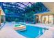 Beautiful screened-in pool with an attached spa and lush greenery for a private oasis at 587 47Th St, Sarasota, FL 34234