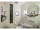 Stylish powder room with a unique sink, round mirror, and tall narrow window at 587 47Th St, Sarasota, FL 34234