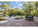 Beautiful backyard with brick patio, gravel fire pit, and lush landscaping at 603 Frances St, Nokomis, FL 34275