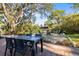 Outdoor dining and fire pit area featuring a table with chairs and a cozy gathering spot at 603 Frances St, Nokomis, FL 34275