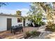 Spacious backyard with brick patio, outdoor seating, and lush tropical plants at 603 Frances St, Nokomis, FL 34275