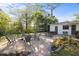 Spacious backyard features outdoor seating, a fire pit, lush trees and landscaping and well-manicured lawns at 603 Frances St, Nokomis, FL 34275