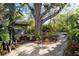 Landscaped backyard with mature oak tree, lush vegetation and ground cover at 603 Frances St, Nokomis, FL 34275