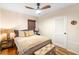 Comfortable bedroom with woven shades, ceiling fan, and stylish furnishings at 603 Frances St, Nokomis, FL 34275