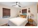 Bright bedroom with woven shades, ceiling fan, and guitars on the wall at 603 Frances St, Nokomis, FL 34275