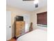 Comfortable bedroom with woven shade, ceiling fan, and rustic wood dresser at 603 Frances St, Nokomis, FL 34275