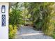 View of a driveway leading to a home, showcasing landscaping at 603 Frances St, Nokomis, FL 34275