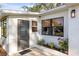 Charming home exterior featuring a side entrance and manicured garden beds at 603 Frances St, Nokomis, FL 34275