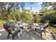 Landscaped backyard features a fire pit circled by Adirondack chairs, perfect for outdoor gatherings at 603 Frances St, Nokomis, FL 34275