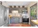 Well-equipped kitchen featuring stainless steel appliances, gray cabinetry, and easy outdoor access at 603 Frances St, Nokomis, FL 34275