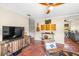 Comfortable living room with terracotta floors, a modern console, and a view into an adjacent room at 603 Frances St, Nokomis, FL 34275