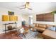 Stylish living room featuring a leather sectional sofa, a unique coffee table, and terracotta tile flooring at 603 Frances St, Nokomis, FL 34275