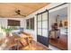 Inviting screened patio featuring a wooden table and terracotta tile flooring, perfect for outdoor dining and relaxation at 603 Frances St, Nokomis, FL 34275