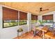 Bright sunroom with wooden ceiling, tile floors, and view of landscaped exterior at 603 Frances St, Nokomis, FL 34275