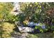 Backyard with a beached boat near waterfront, framed by lush tropical greenery and trees at 603 Frances St, Nokomis, FL 34275