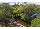 A scenic aerial view of a lush landscape highlighting the property's serene waterfront location at 603 Frances St, Nokomis, FL 34275