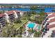 Aerial view of the community pool, condos, and waterfront location at 6285 Midnight Pass Rd # 201, Sarasota, FL 34242