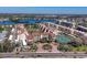 Aerial view of condo community with lake views, tennis courts, and meticulous landscaping at 6285 Midnight Pass Rd # 201, Sarasota, FL 34242