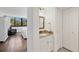 Bathroom with a granite vanity, tile floors, and closet, adjacent to a light-filled bedroom at 6285 Midnight Pass Rd # 201, Sarasota, FL 34242