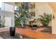Charming courtyard with seating, lush greenery, and elegant chandelier at 6285 Midnight Pass Rd # 201, Sarasota, FL 34242
