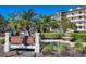 Elegant entryway sign for Excelsior Beach to Bay Condominiums with fountain and manicured landscaping at 6285 Midnight Pass Rd # 201, Sarasota, FL 34242