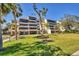 Well-maintained condo building featuring covered parking and lush landscaping at 6285 Midnight Pass Rd # 201, Sarasota, FL 34242