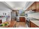 Open-concept kitchen featuring stainless steel appliances, wood cabinets, and a view of the living area at 6285 Midnight Pass Rd # 201, Sarasota, FL 34242