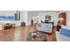 Open-concept living area showcasing wood floors, comfortable sofa and seamless flow to the dining area at 6285 Midnight Pass Rd # 201, Sarasota, FL 34242