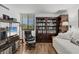 Cozy living room showcasing a bookshelf, a daybed, and a comfortable leather chair at 6285 Midnight Pass Rd # 201, Sarasota, FL 34242