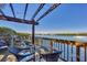 Inviting outdoor deck featuring a pergola, cozy seating, and scenic water views at 6285 Midnight Pass Rd # 201, Sarasota, FL 34242