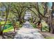 Scenic pathway with benches and pond views, leading to the condo building at 6285 Midnight Pass Rd # 201, Sarasota, FL 34242