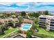 Stunning aerial view of community showcasing the pool, docks, landscaping, and nearby ocean at 6342 Midnight Pass Rd # 212, Sarasota, FL 34242