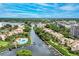 Expansive aerial view of the waterfront community highlighting the canal, docks, and lush landscaping at 6342 Midnight Pass Rd # 212, Sarasota, FL 34242