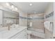 Bright bathroom showcases a shower over tub, neutral tile and modern fixtures at 6342 Midnight Pass Rd # 212, Sarasota, FL 34242