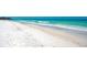 Wide sandy beach with clear blue water, perfect for swimming and relaxation at 6342 Midnight Pass Rd # 212, Sarasota, FL 34242