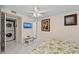 Bright bedroom with overhead fan and en-suite laundry area offers added convenience at 6342 Midnight Pass Rd # 212, Sarasota, FL 34242